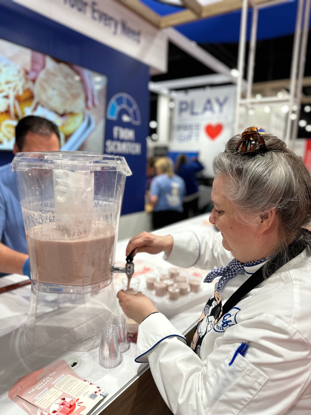 Chef Monica pouring YoLatte Tea coolers into cups at ANC