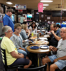 people celebrating eating pizza